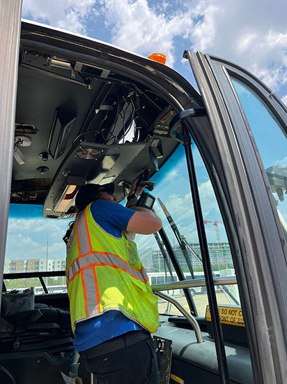 A tech installs security on a bus